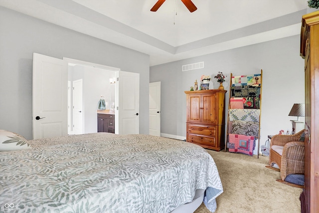 bedroom with visible vents, a ceiling fan, connected bathroom, and light colored carpet