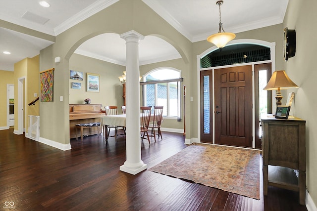 foyer with wood-type flooring, ornamental molding, baseboards, ornate columns, and arched walkways