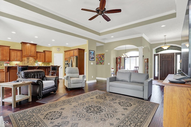 living room with baseboards, recessed lighting, arched walkways, dark wood finished floors, and ceiling fan with notable chandelier