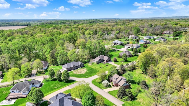 birds eye view of property featuring a residential view and a forest view