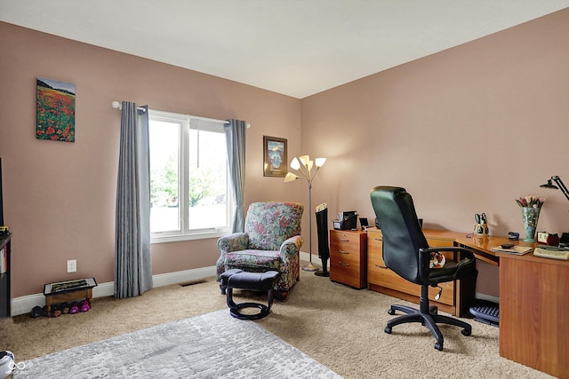 carpeted office space with baseboards and visible vents