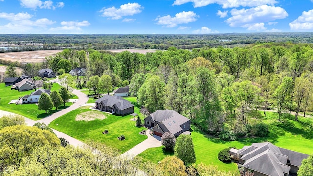 drone / aerial view featuring a residential view and a forest view