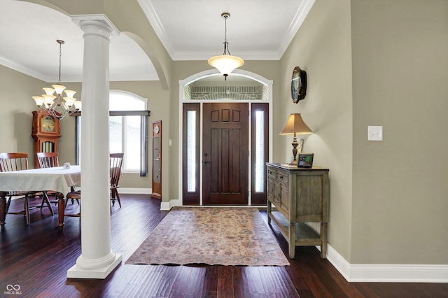 foyer with ornamental molding, baseboards, ornate columns, dark wood-type flooring, and arched walkways