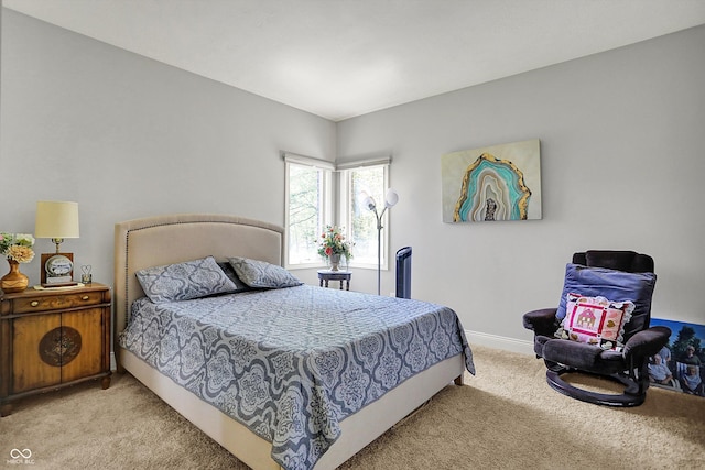 bedroom with baseboards and light colored carpet