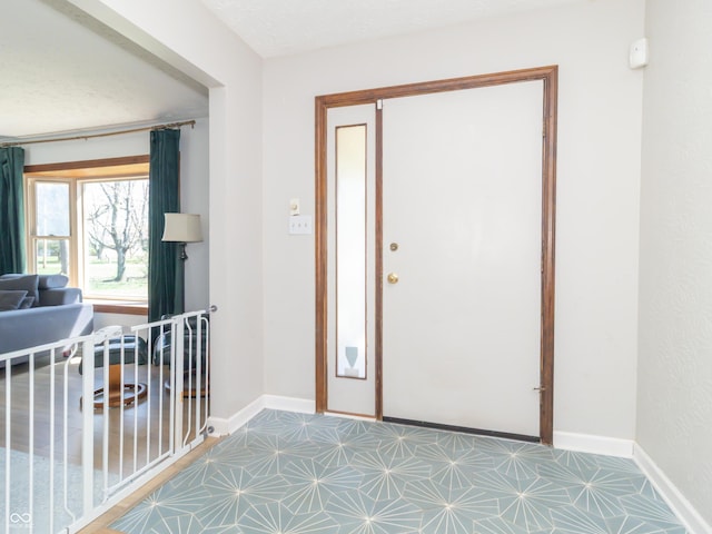 entrance foyer with tile patterned floors and baseboards