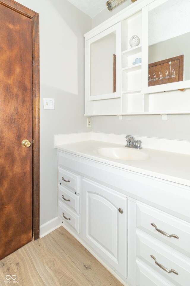 bathroom featuring vanity and wood finished floors