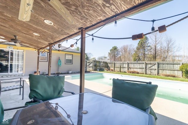 view of patio with a fenced backyard, ceiling fan, and a fenced in pool