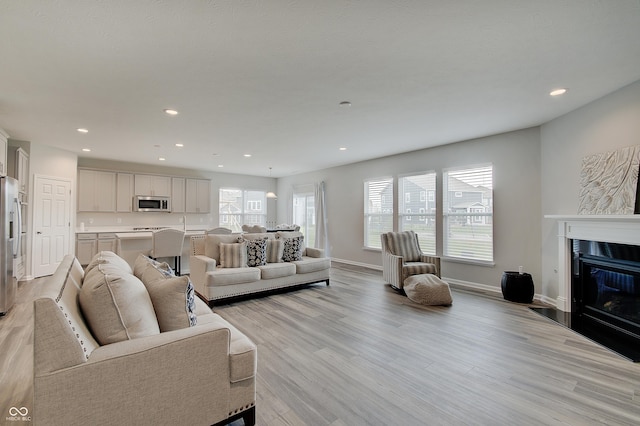3799 Hoosier Down Dr, Bargersville, IN 46106 - living area featuring a fireplace, baseboards, light wood-style floors, and recessed lighting