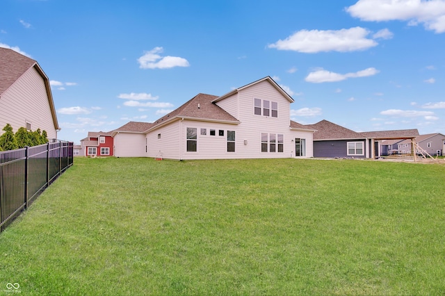3799 Hoosier Down Dr, Bargersville, IN 46106 - back of property with a lawn, a shingled roof, and fence