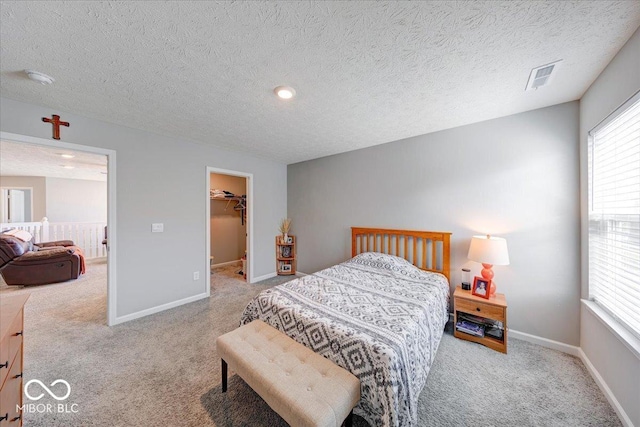 5839 Altar Bell Cir, Greenwood, IN 46143 - carpeted bedroom with a walk in closet, multiple windows, baseboards, and visible vents