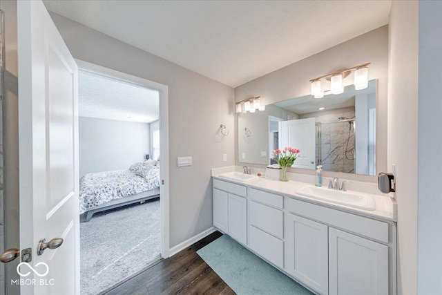 5839 Altar Bell Cir, Greenwood, IN 46143 - full bathroom featuring a sink, double vanity, a shower stall, and wood finished floors