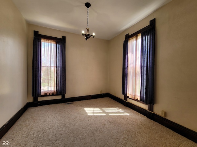 2628 N 150 E, Rushville, IN 46173 - carpeted spare room featuring a chandelier, baseboards, and visible vents