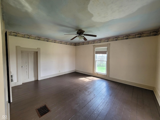 2628 N 150 E, Rushville, IN 46173 - spare room featuring dark wood-style flooring, visible vents, baseboards, and a ceiling fan
