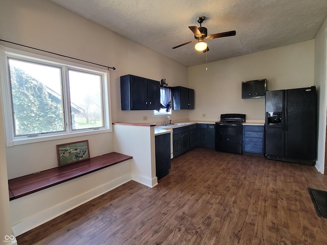 2628 N 150 E, Rushville, IN 46173 - kitchen with visible vents, light countertops, black appliances, and dark wood-style floors