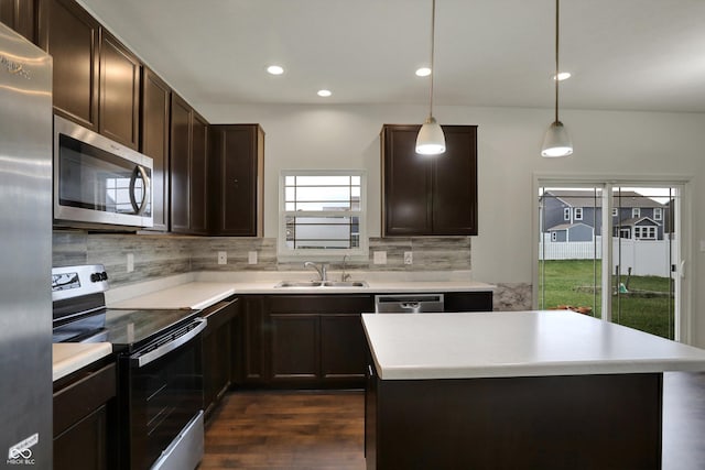 kitchen featuring tasteful backsplash, light countertops, dark brown cabinets, stainless steel appliances, and a sink