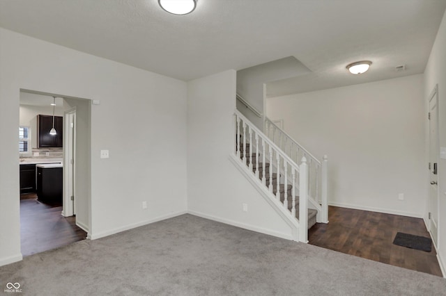 interior space with baseboards, carpet, and stairway