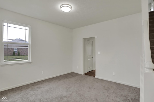 empty room with carpet floors and baseboards