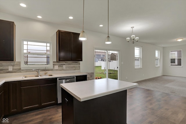 kitchen featuring tasteful backsplash, dishwasher, a sink, open floor plan, and dark brown cabinets