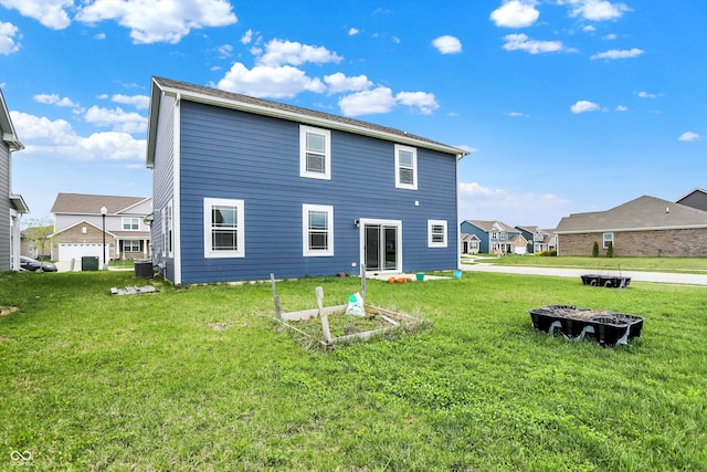 back of house with a lawn