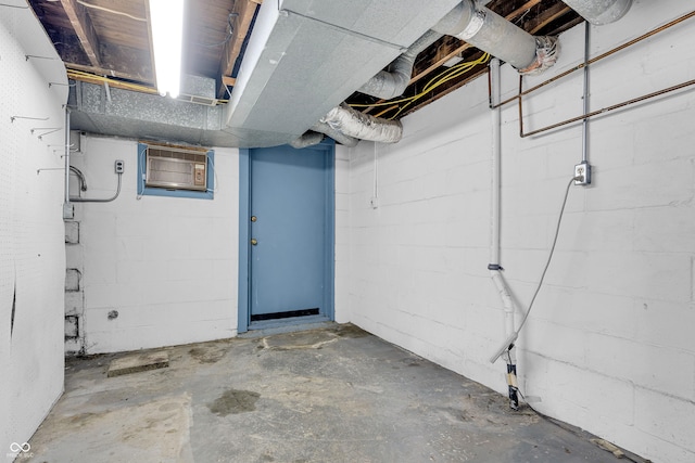 unfinished below grade area featuring a wall mounted air conditioner