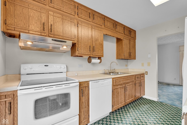 kitchen with white appliances, under cabinet range hood, a sink, and light countertops