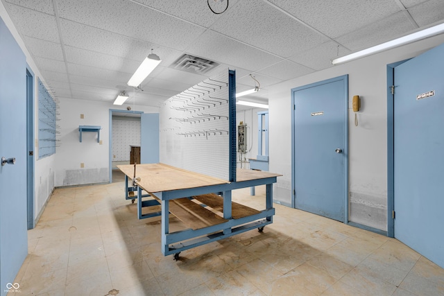 interior space featuring visible vents and a drop ceiling