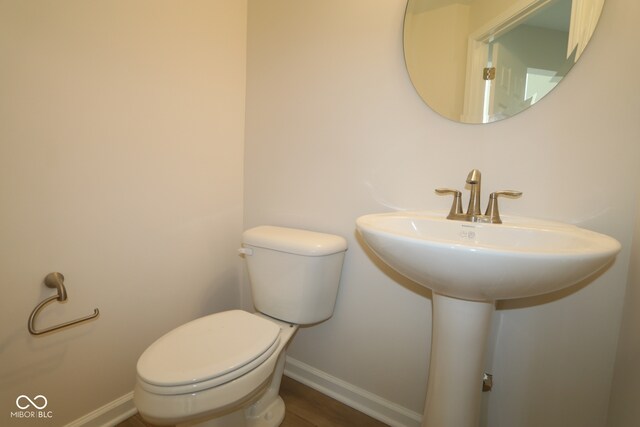 10543 Banyan Wood Ct, Indianapolis, IN 46239 - bathroom with baseboards, toilet, and wood finished floors