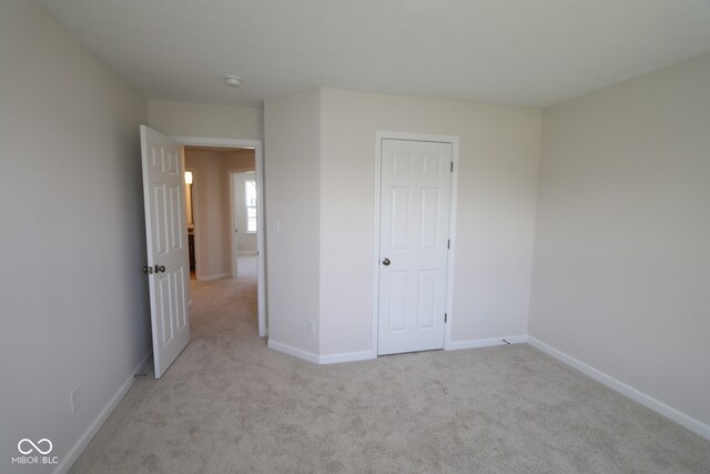 10543 Banyan Wood Ct, Indianapolis, IN 46239 - unfurnished bedroom with light colored carpet and baseboards
