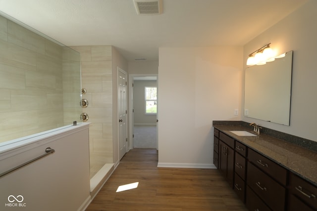 10543 Banyan Wood Ct, Indianapolis, IN 46239 - bathroom featuring wood finished floors, a walk in shower, vanity, and baseboards