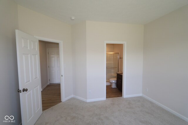 10543 Banyan Wood Ct, Indianapolis, IN 46239 - unfurnished bedroom featuring carpet flooring, baseboards, and connected bathroom