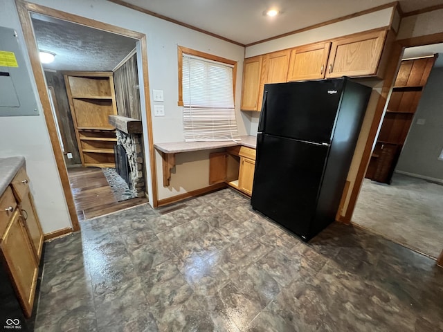 2260 N Graham Ave, Indianapolis, IN 46218 - kitchen featuring freestanding refrigerator, crown molding, light countertops, light brown cabinetry, and electric panel