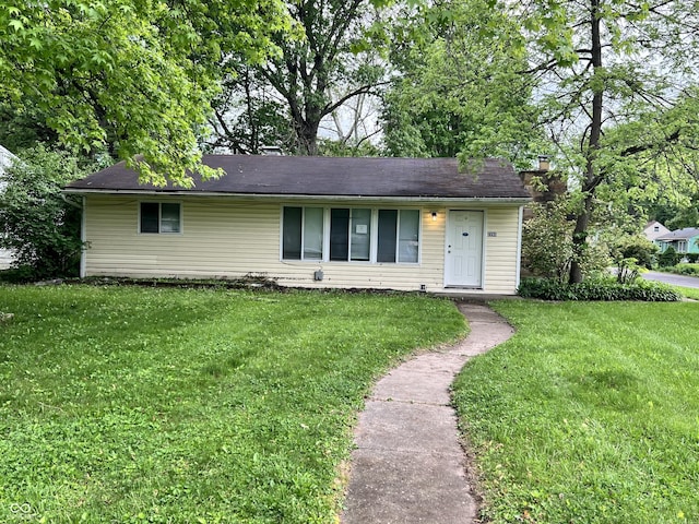2260 N Graham Ave, Indianapolis, IN 46218 - ranch-style house featuring a front yard and a chimney