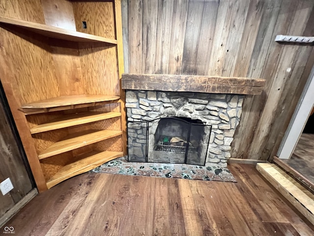 2260 N Graham Ave, Indianapolis, IN 46218 - detailed view of wood finished floors, wood walls, and a stone fireplace
