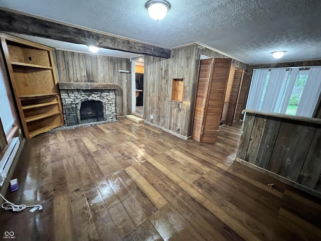 2260 N Graham Ave, Indianapolis, IN 46218 - unfurnished living room with wood-type flooring, a textured ceiling, wooden walls, a fireplace, and a baseboard radiator