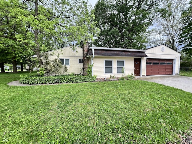 2260 N Graham Ave, Indianapolis, IN 46218 - single story home with a garage, concrete driveway, and a front lawn