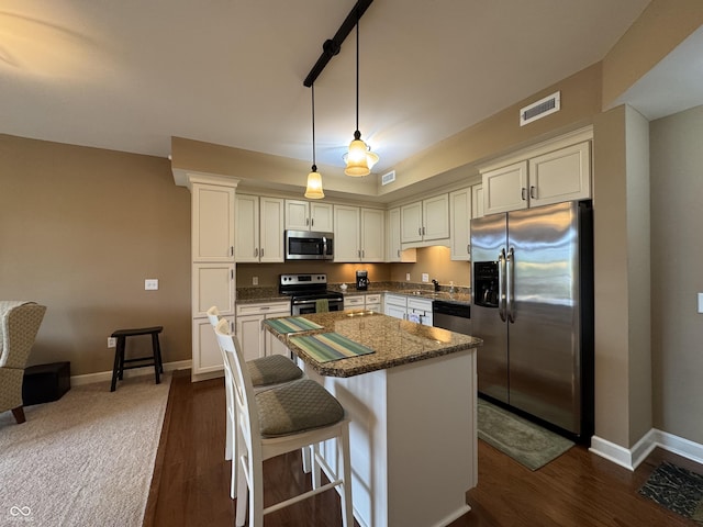 20971 Shoreline Ct Unit 214, Noblesville, IN 46062 - kitchen featuring visible vents, baseboards, a center island, white cabinetry, and appliances with stainless steel finishes