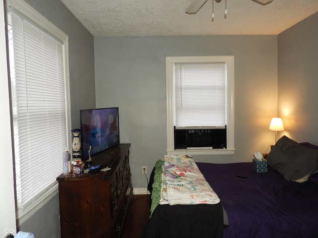 4920 E 34th St, Indianapolis, IN 46218 - bedroom with baseboards, a textured ceiling, and ceiling fan