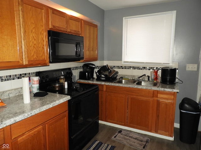 4920 E 34th St, Indianapolis, IN 46218 - kitchen featuring black appliances, a sink, brown cabinets, tasteful backsplash, and dark wood-style flooring