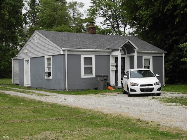 4920 E 34th St, Indianapolis, IN 46218 - ranch-style home with a chimney, a shingled roof, and a front yard