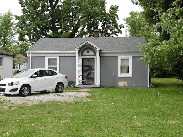4920 E 34th St, Indianapolis, IN 46218 - single story home featuring a shingled roof, a front lawn, and a chimney