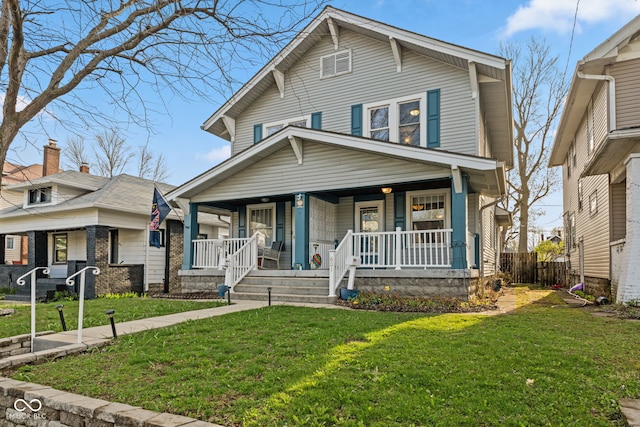601 Wallace Ave, Indianapolis, IN 46201 - traditional style home featuring a front yard, a porch, and fence