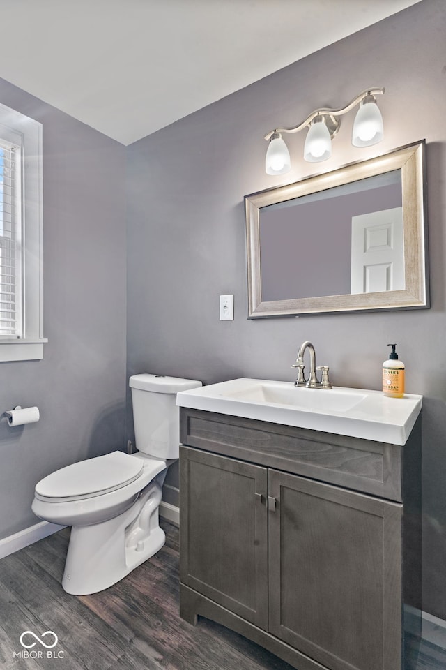 601 Wallace Ave, Indianapolis, IN 46201 - bathroom featuring toilet, wood finished floors, vanity, and baseboards