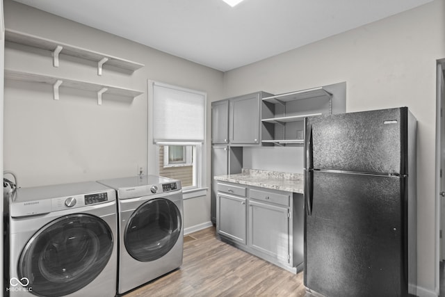 601 Wallace Ave, Indianapolis, IN 46201 - laundry room featuring cabinet space, light wood-style flooring, separate washer and dryer, and baseboards