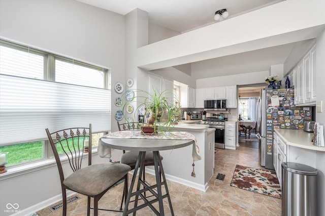 10518 Greenway Dr, Fishers, IN 46037 - kitchen featuring white cabinets, stone finish flooring, visible vents, light countertops, and stainless steel appliances