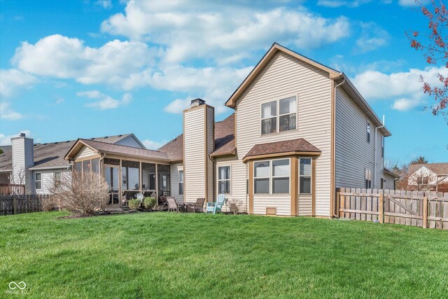 10518 Greenway Dr, Fishers, IN 46037 - rear view of property with a shingled roof, fence private yard, a sunroom, and a lawn