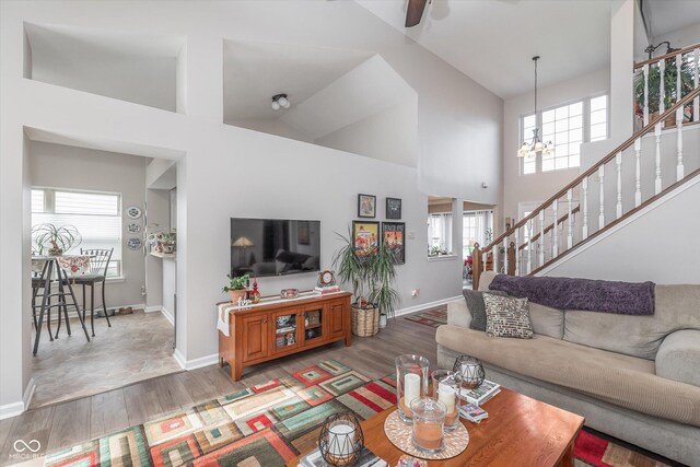 10518 Greenway Dr, Fishers, IN 46037 - living room featuring stairway, a high ceiling, and wood finished floors