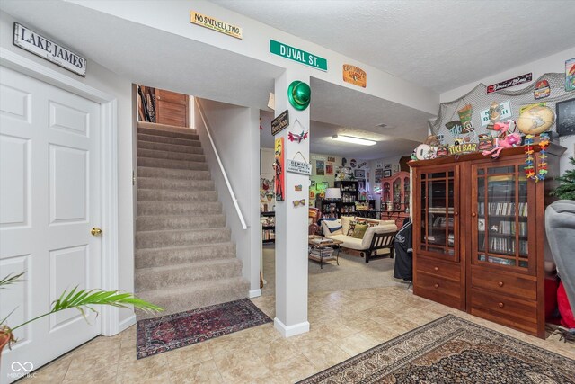 10518 Greenway Dr, Fishers, IN 46037 - staircase featuring a textured ceiling