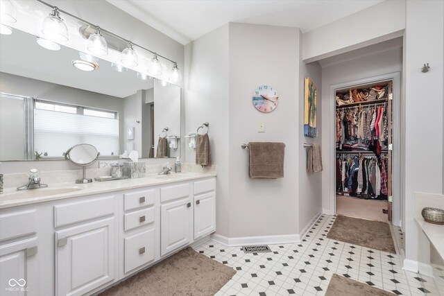 10518 Greenway Dr, Fishers, IN 46037 - full bathroom featuring a sink, double vanity, baseboards, and a walk in closet