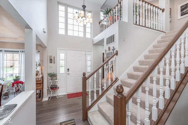 10518 Greenway Dr, Fishers, IN 46037 - entrance foyer with baseboards, an inviting chandelier, stairs, visible vents, and wood finished floors