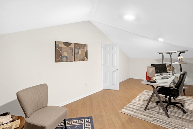 home office with baseboards, wood finished floors, and vaulted ceiling